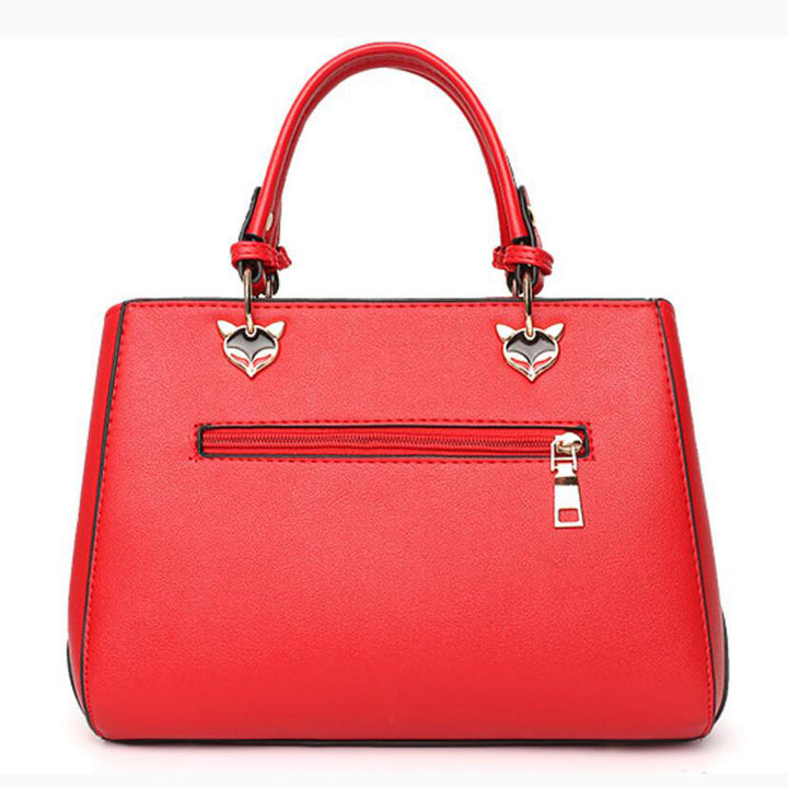 Colorblock handbag with pom-pom charm