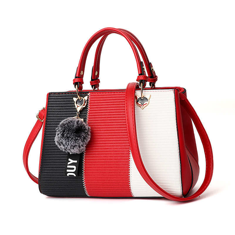 Colorblock handbag with pom-pom charm