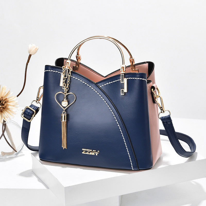 Color block handbag with heart tassel