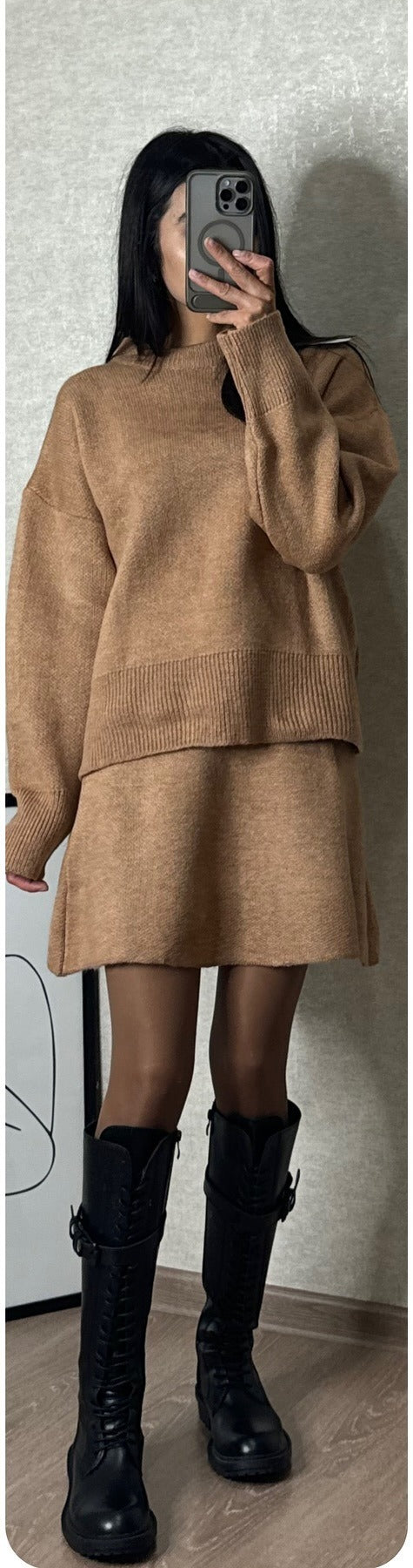 Woman in matching knit sweater and mini skirt set