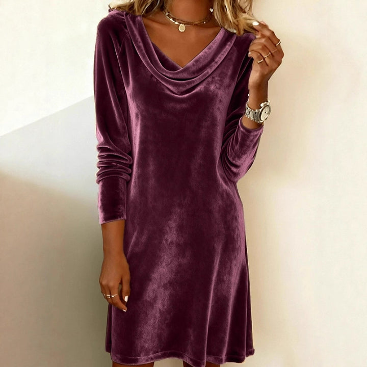 Woman in a velvet cowl neck mini dress