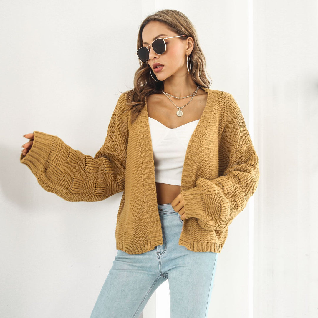 Woman in chunky cable knit puff sleeve cardigan
