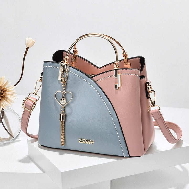 Color block handbag with heart tassel